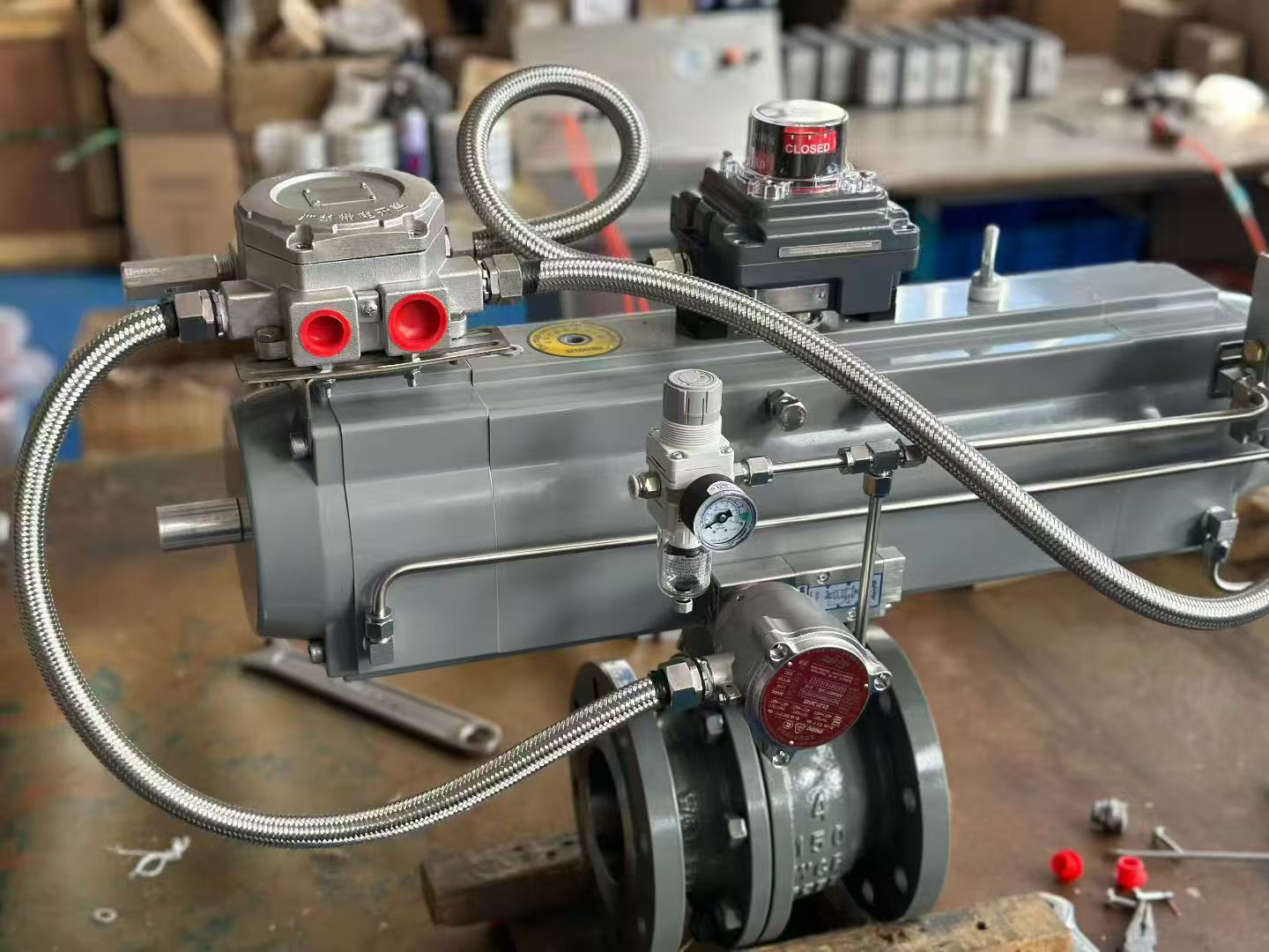 Workshop assembly details of a three-stage pneumatic actuator showing solenoid valves and braided tubing